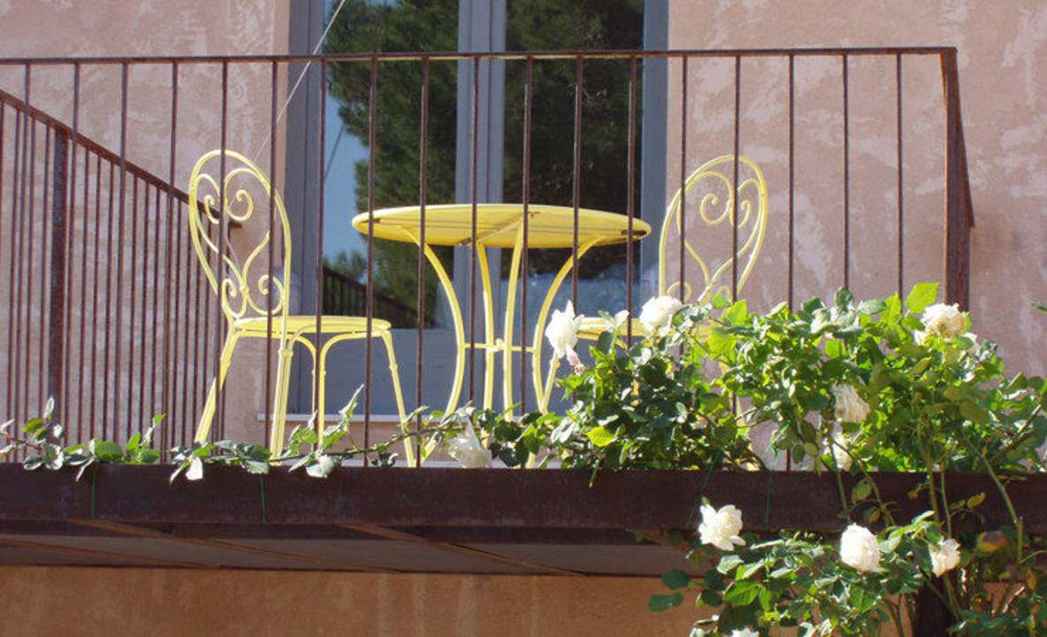 Terrace and rosebush Rusticae Hotel Spa La Romana