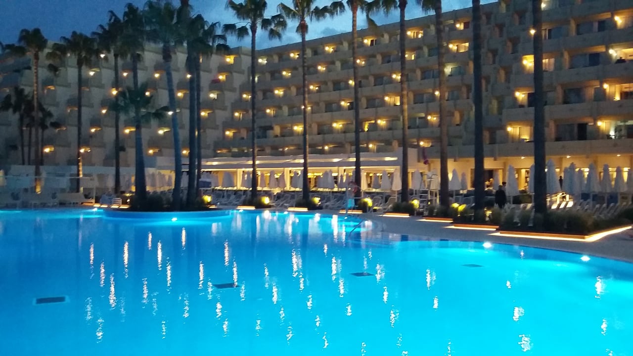 Blick vom Pool auf das Hotel abends Hipotels Mediterraneo