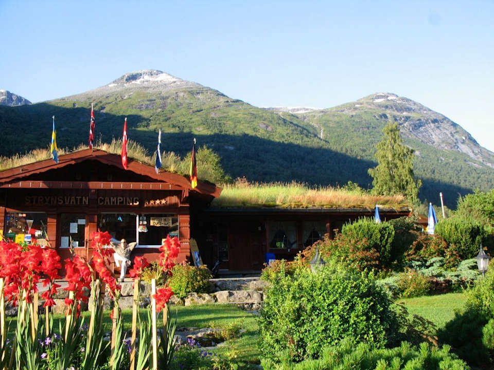 Wooden huts with flowers Strynsvatn Camping