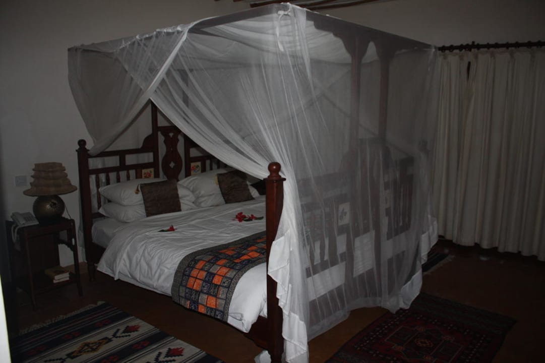 Bett mit obligatorischem Mosquitonetz Neptune Palm Beach Boutique Resort & Spa