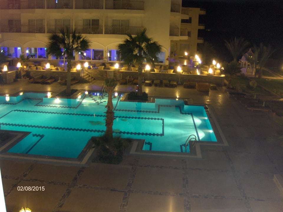 Pool lit by night Royal Star Beach Resort