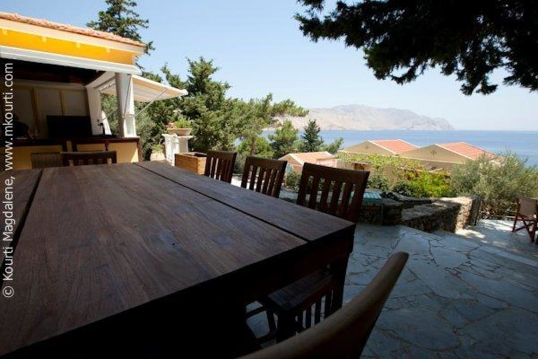 The bar terrace under a huge tree Hotel Niriides