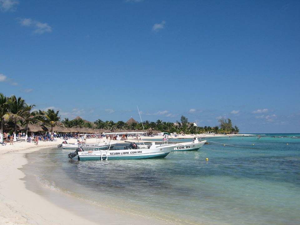 Hotelstrand mit Booten von Scuba Libre Sandos Caracol Eco Resort
