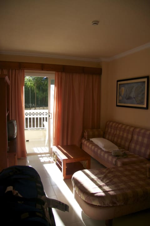 Das Wohnzimmer des Apartments Green Garden Aparthotel