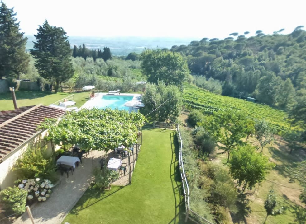 The garden and the pool from a window. Agriturismo La Tinaia