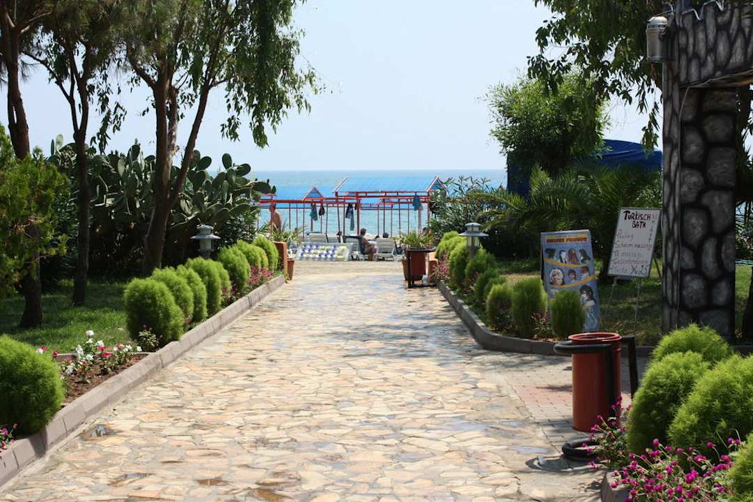 Weg zum Strand Club Turtas Beach Hotel