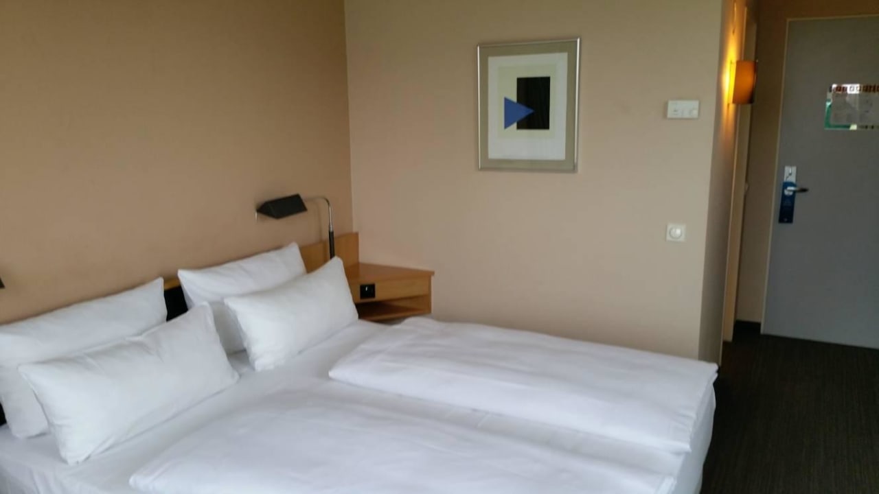Doppelbett und Eingang Hotel NH Düsseldorf City