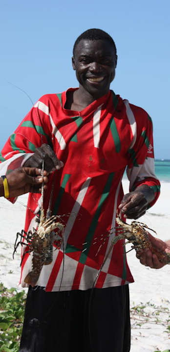 Suleimann mit frischem Fang Hotel Karibuni Rafiki Beach Resort