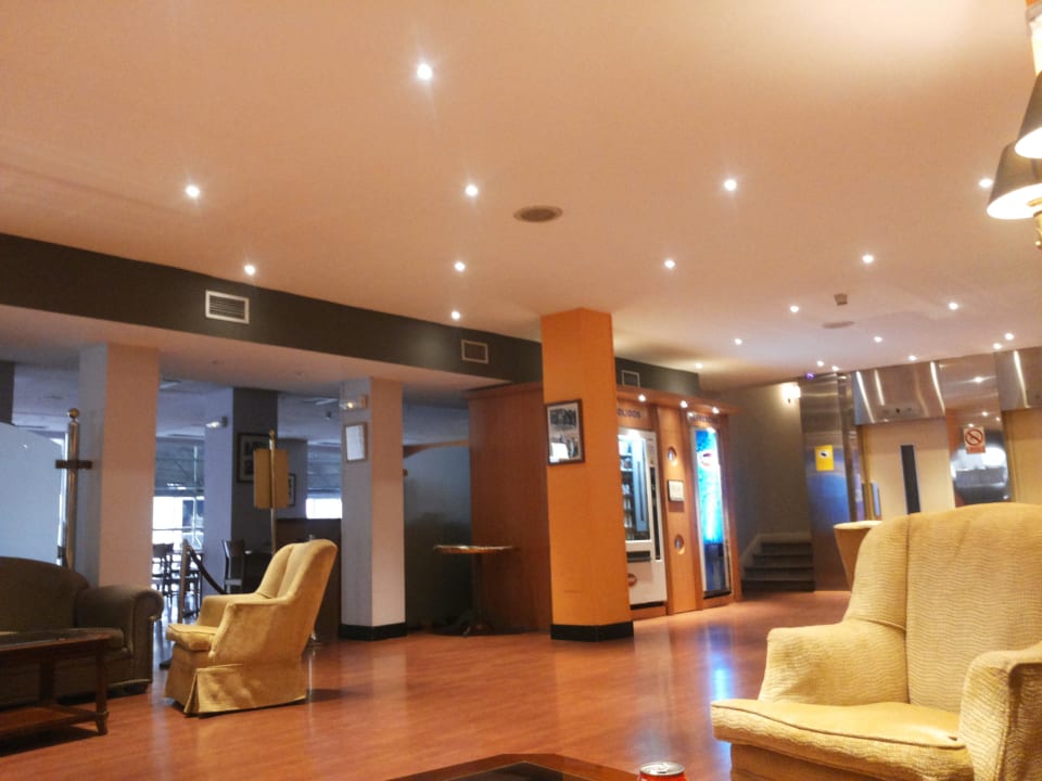 Kącik wypoczynkowy i w tle wejście do restauracji Hotel Madrid Gran Vía by Melia