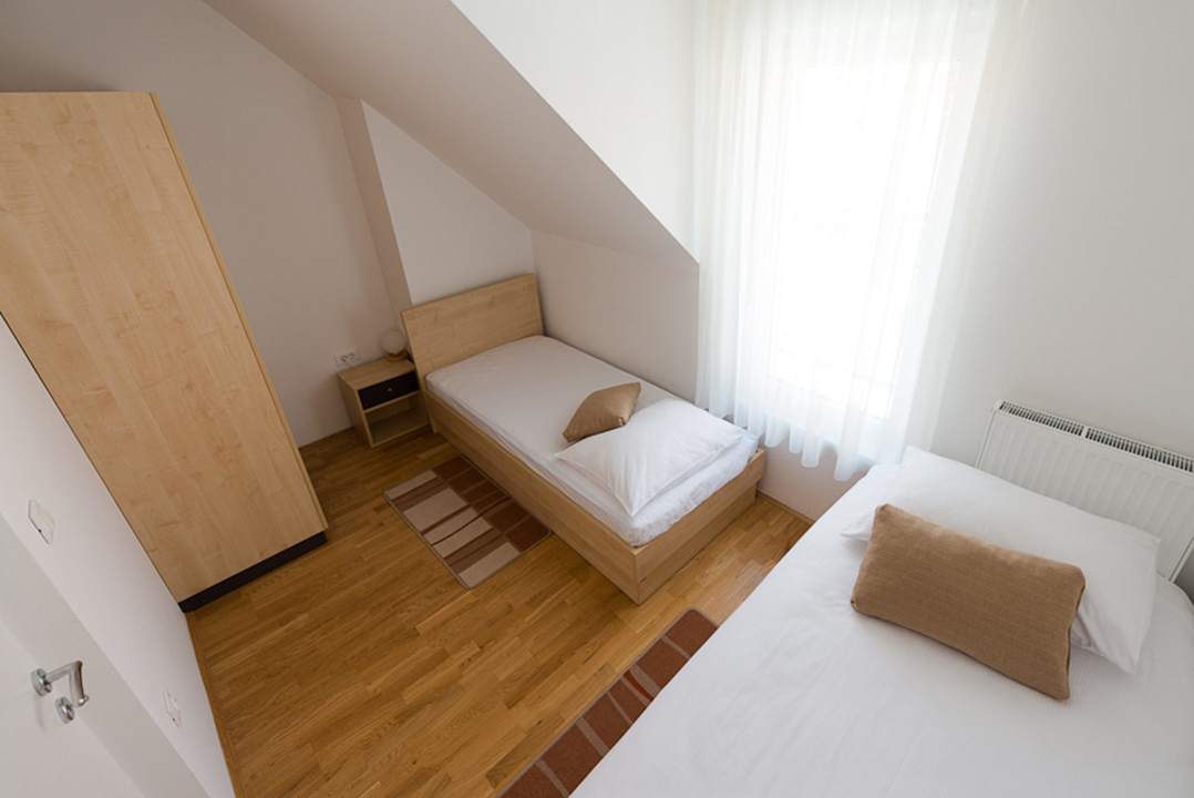 Two single beds in standard quadruple room Postojna cave Rooms & Apartments Proteus