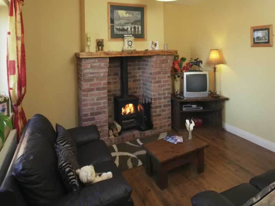 Sitting room with wood burning stove Tralee Bay Holiday Village
