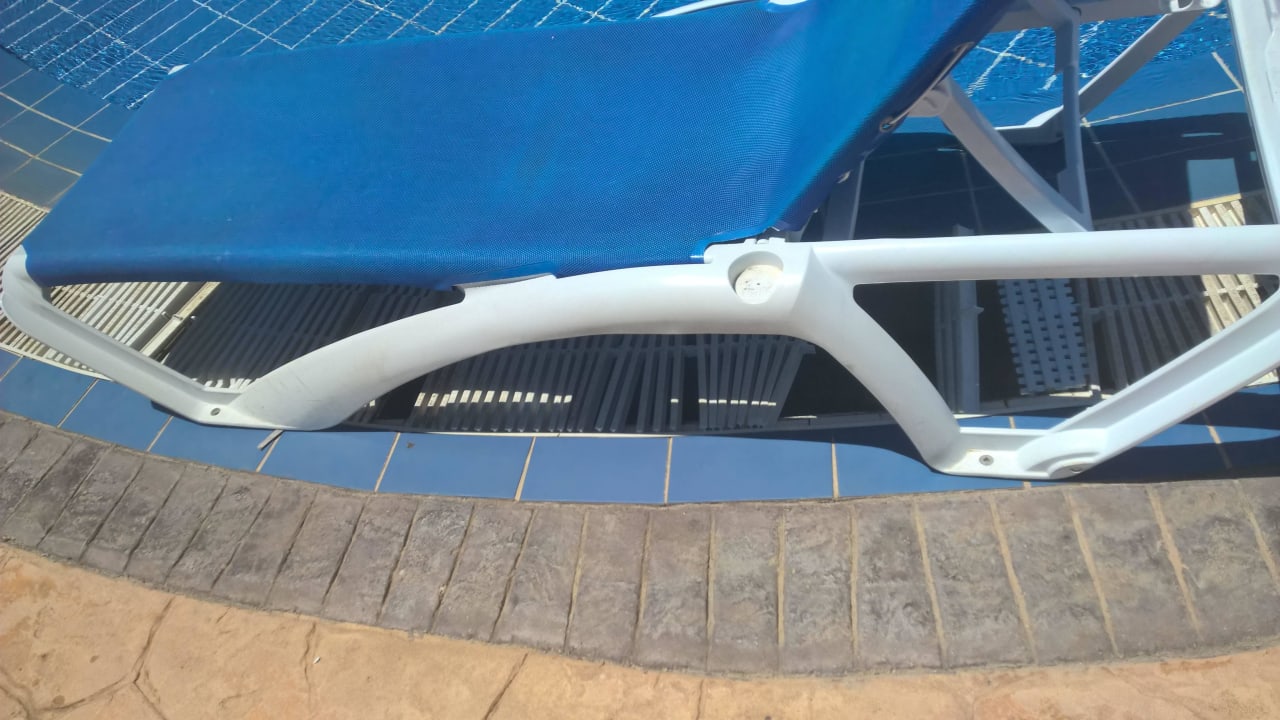 Broken pool gutter covered with pool chair Iberostar Origin Laguna Azul