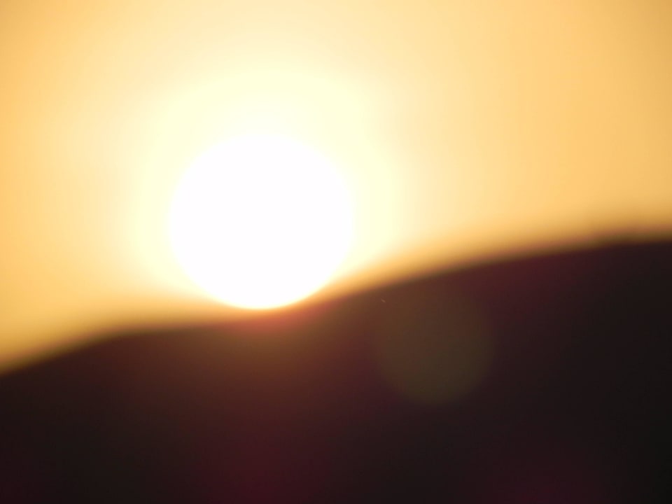 Sunset over the sand dune Qasr Al Sarab Desert Resort by Anantara