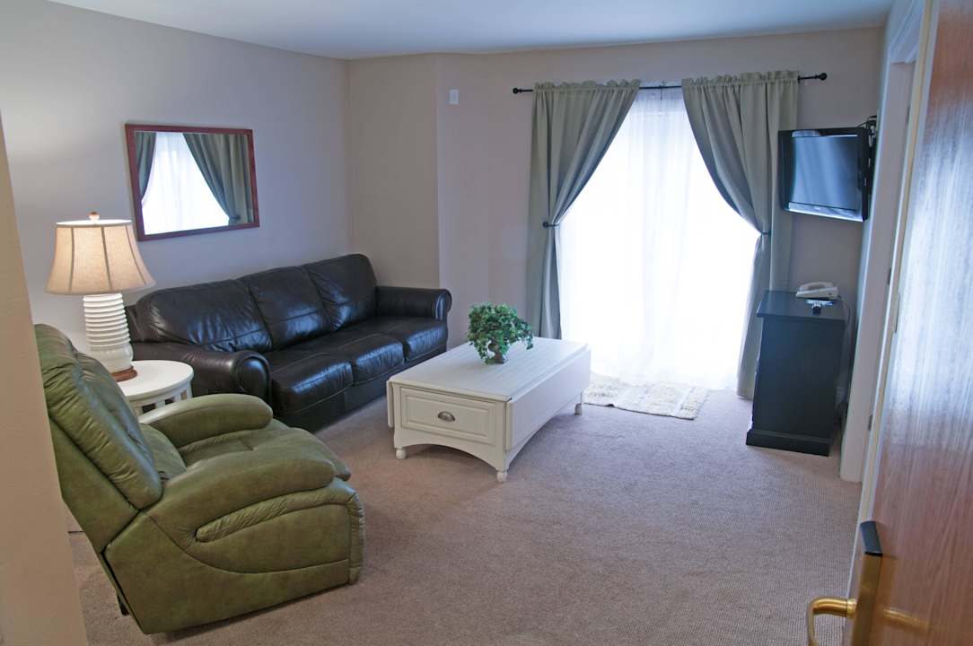 King Suite, Pet Friendly, Lake View - Living Area Charlevoix Inn & Suites, SureStay Collection by Best Western