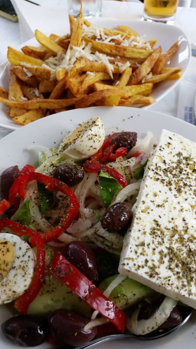 Delicious greek salad with homemade  fries Asterias Beach Resort