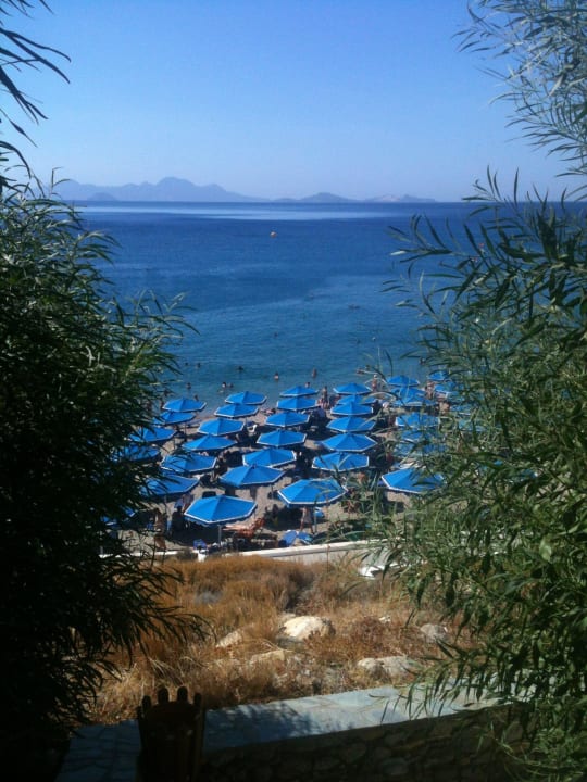 Beach and Nisyros volcano island Mitsis Summer Palace