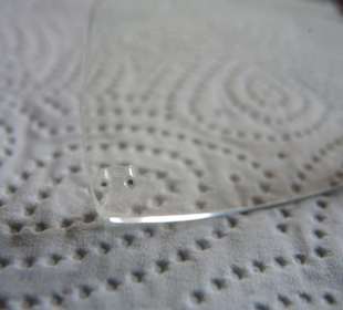 Brillenglas  mit den abgebrochenen Stiften