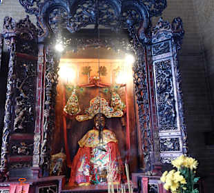 Altar mit bemalten Keramikfiguren