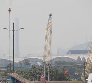 The main building , behind the cranes