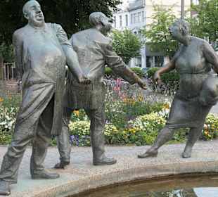 Kreislauf des Geldes, Brunnen beim Elisengarten