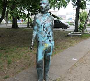 Skulptur Stehende Figur vor Reliefkörpern