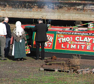 Decorated barge and people in traditional costume