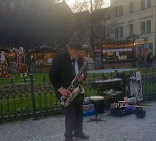 Saxophonspieler am Rande eines Weihnachtsmarktes