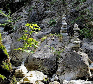 Steinpyramiden in der Schlucht neben dem Bach