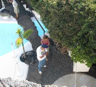 Blick von oben auf Pool und Brücke