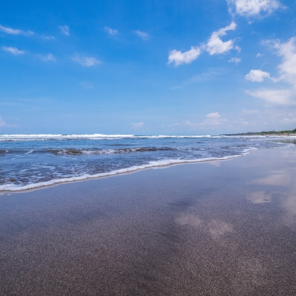 View Of Beach Against Cloudy Sky