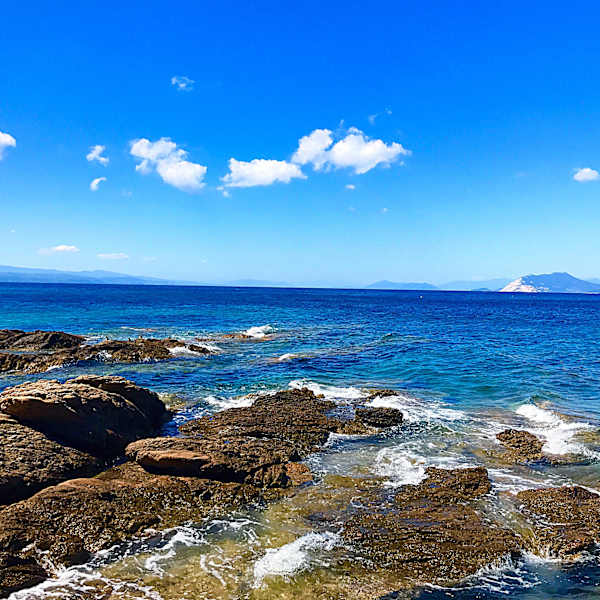 Scenic View Of Sea Against Blue Sky